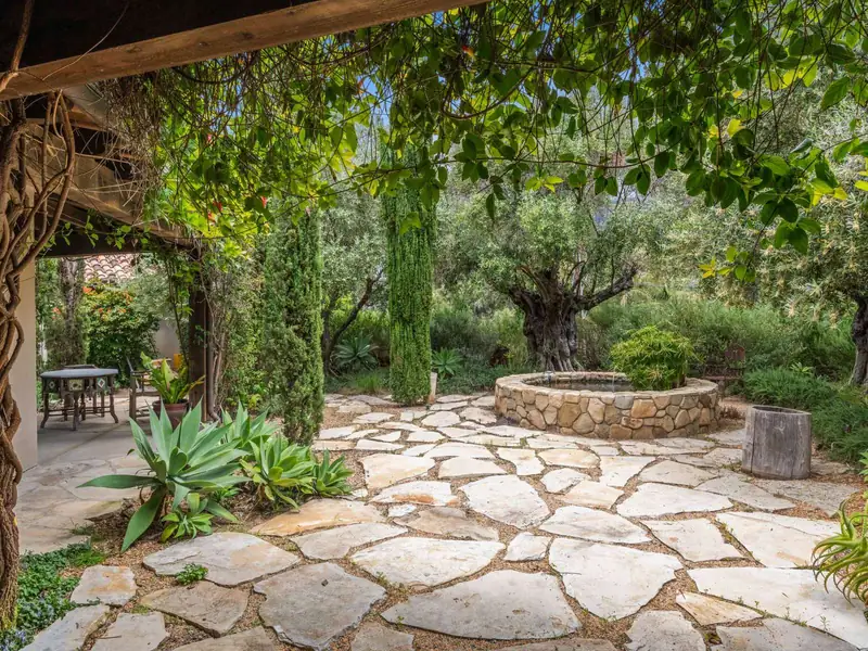 Flagstone courtyard with agave, stone fountain and drought-tolerant plantings